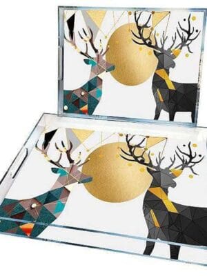 Description: Add a touch of modern elegance to your serving table with this luxurious set of serving trays. These trays feature a distinctive geometric deer design with intricate, intertwined shapes and shiny golden accents, creating an eye-catching piece that enhances any space. Suitable for serving or as decor in the living room, these trays add a unique charm to any home. Specifications: Material: High-quality, durable transparent glass with golden metallic accents Quantity: Set of 2 in different sizes Dimensions: Large Tray: 45 × 30 cm Small Tray: 35 × 25 cm Design: Colorful geometric deer patterns with gold detailing Usage: For serving or as a chic decorative piece Durability: Glass layer protects the design, ensuring colors remain vibrant over time Features: Contemporary design complements various interior styles Ideal for serving coffee, tea, snacks, or as a decorative tray Easy to clean; simply wipe with a damp cloth Side handles for easy carrying and use Ideal Usage: Use these trays to serve drinks and snacks to guests or place them as an elegant decorative piece on the coffee table or buffet. Their sophisticated design makes them a perfect choice for adding an artistic touch to modern homes.